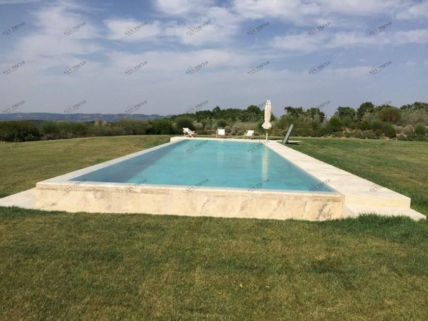 INDALO PISCINE Пейзажный бассейн из травертина с водопадом sun-id-1478056