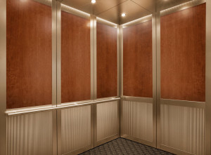 FSRT844 Интерьер лифта Levelc-2000n с верхними панелями из шпона американской вишни; нижние панели из плавленой бронзы, отделка морским камнем, узор далласского тиснения; стойки и поручни из плавленой бронзы, отделка кайзером; секстант поручень из атласно